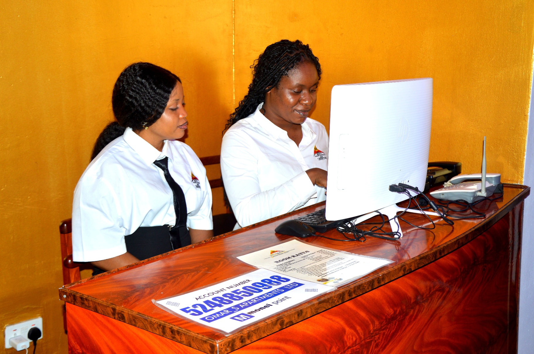 Reception team assisting a booking